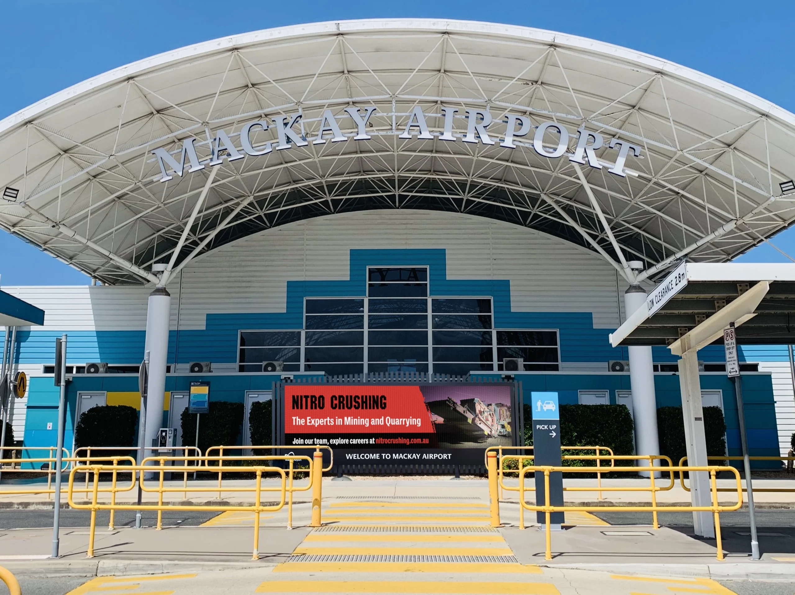 Front entrance of Mackay Airport featuring a digital billboard